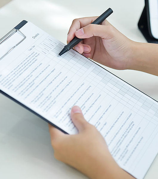 female working with a to do list and pen at desk